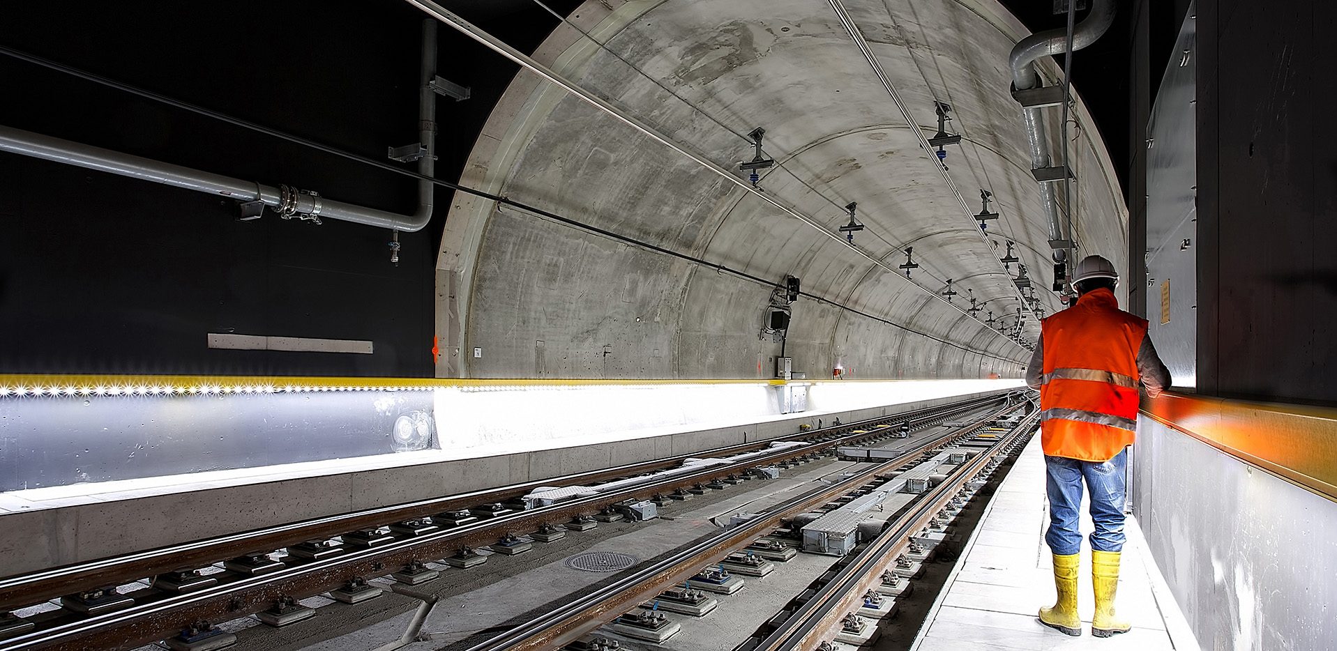 A picture of a construction worker inside a rail tunnel