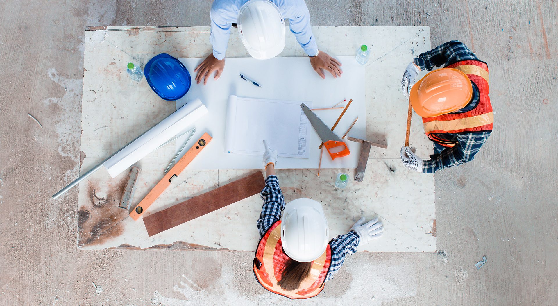A group of construction workers looking over some plans