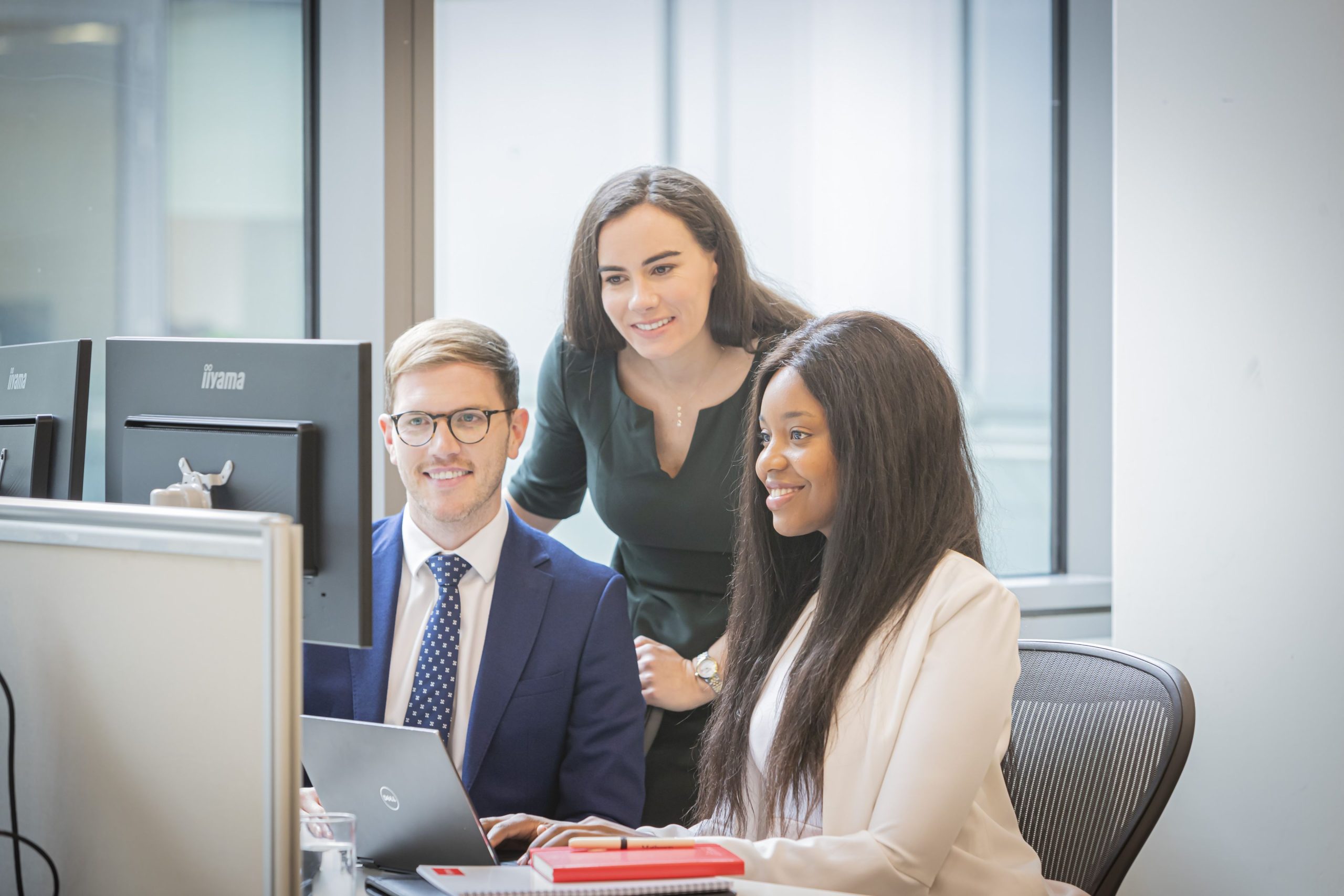 Members of the Matheson digital services group looking at a computer