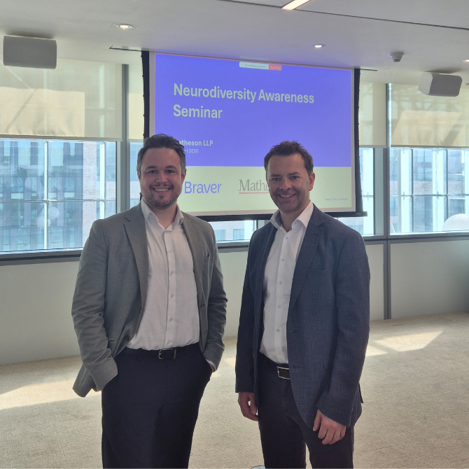 Mark Scully and Darren Maher standing in a bright meeting room in front of a presentation screen displaying the title “Neurodiversity Awareness Seminar,” with Matheson and Braver logos visible behind them.